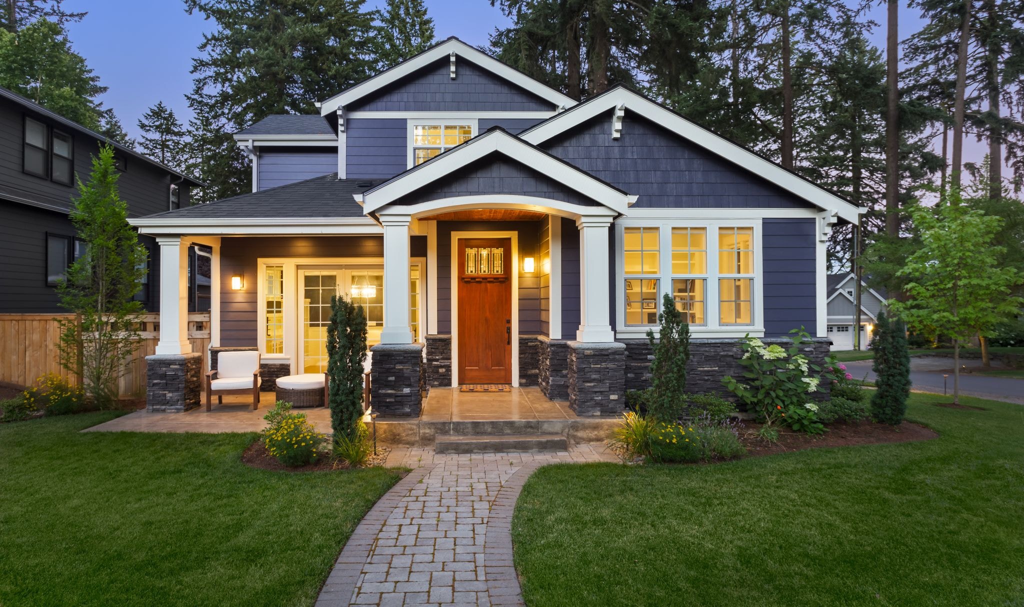 Small family home with interior lights on at twilight.