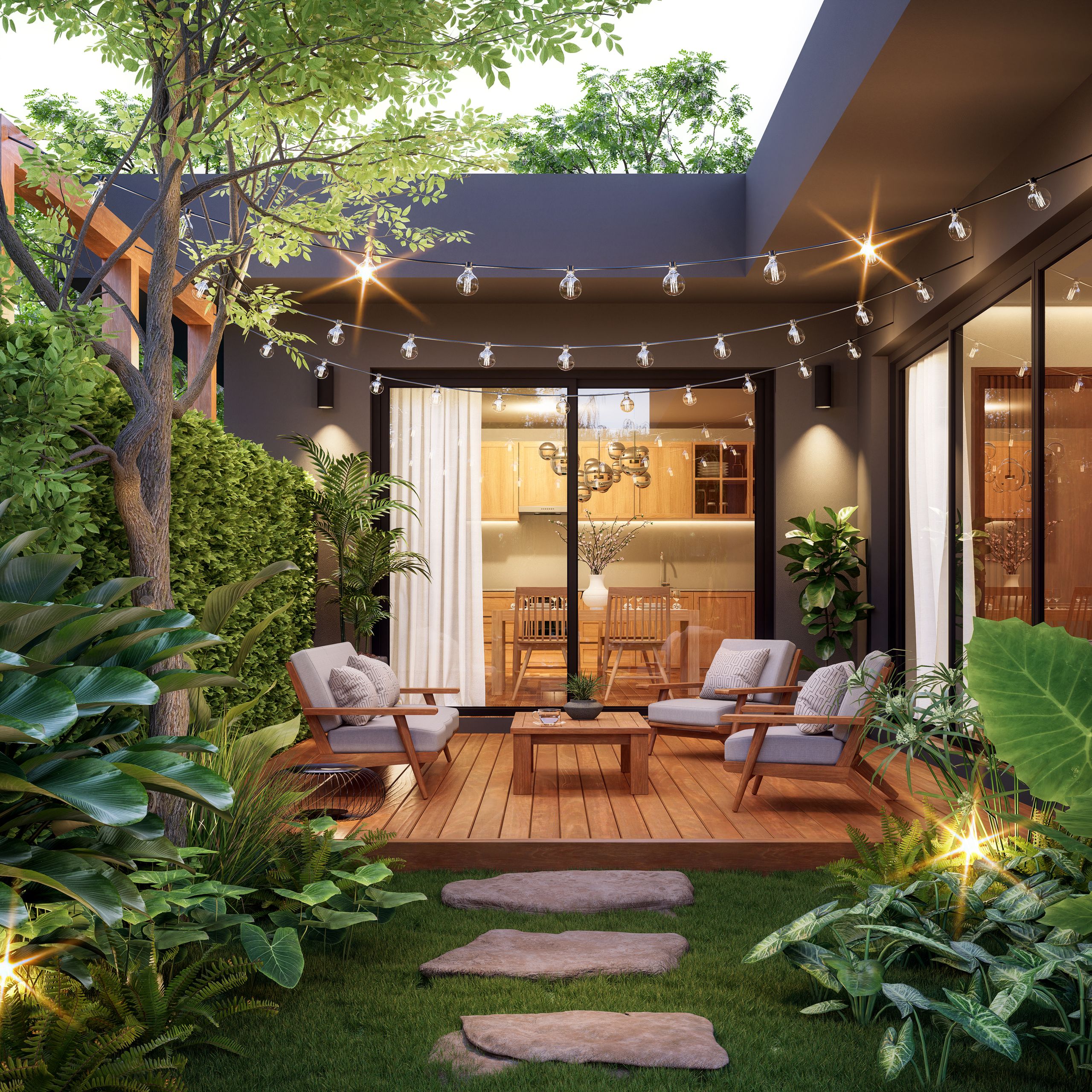 Interior lights shine through large glass windows of a modern home. Patio furniture is seen below rows of string lights.